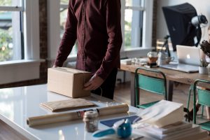 man wrapping and packing a box